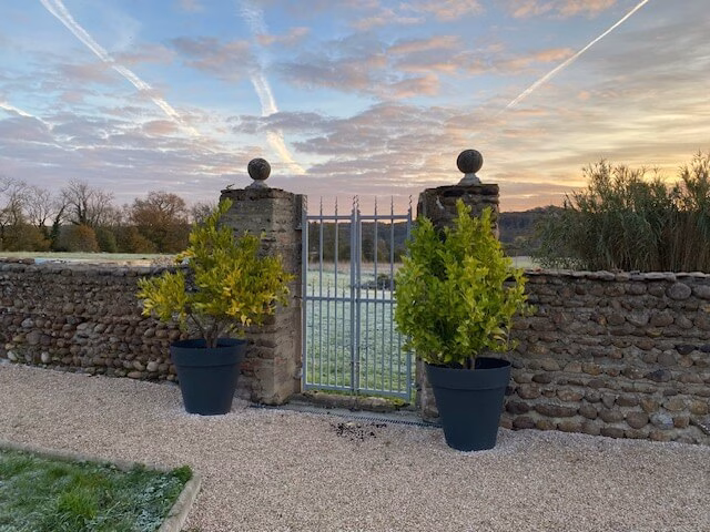 Courtyard gates at Peyroulat looking out onto the Louet valley. Frost on the ground and a lovely morning winter sky.